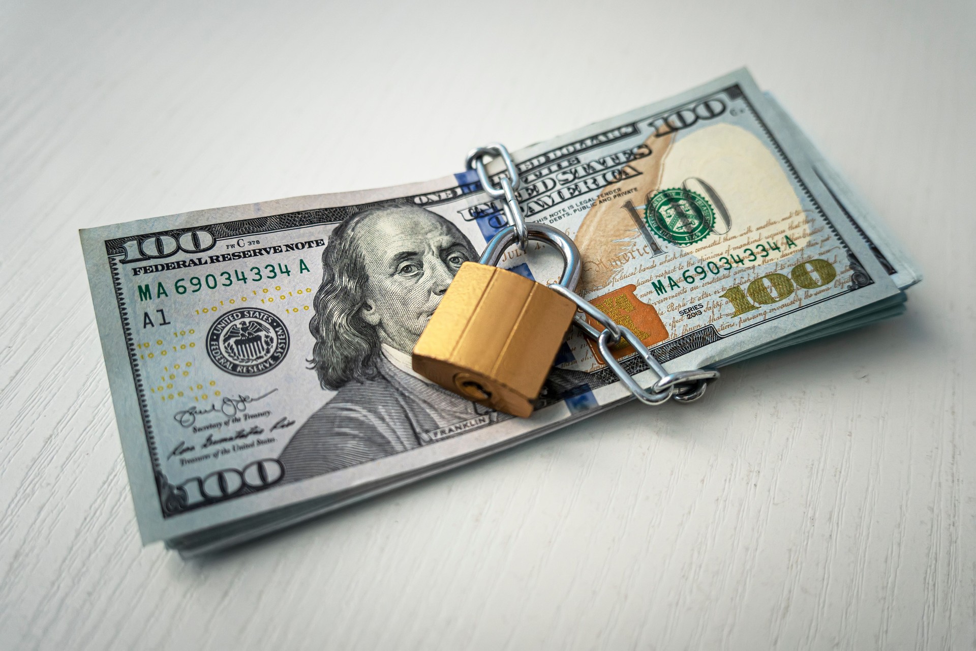 money dollars in a chain with lock on the background of white. The concept of banning dollars. the concept of keeping or banning cash dollars. money is banned.